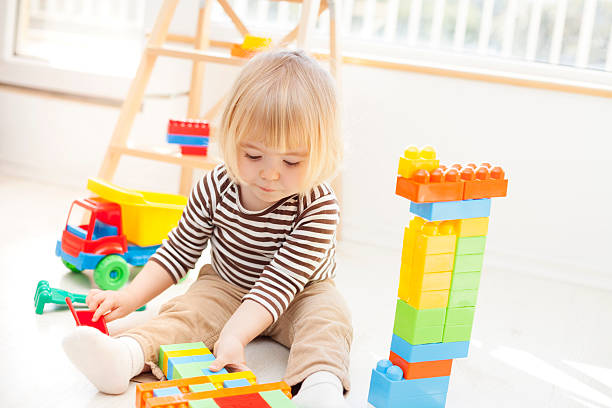 istock Little child playing with colorful plastic blocks 629777132