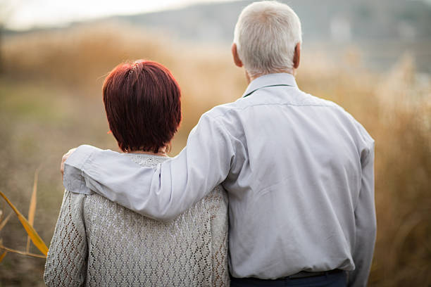 istock Senior Couple Walking Through Autumn Countryside 629778214