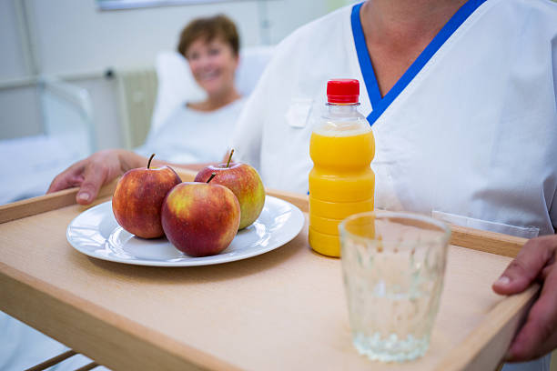 istock Mid section of nurse holding a breakfast 629779034