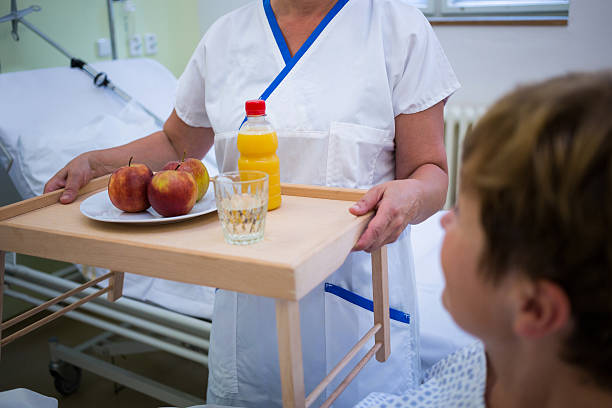 istock Nurse serving a breakfast to patient 629779040