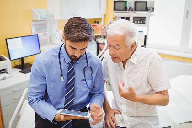 istock Doctor discussing with patient over digital tablet 629779848