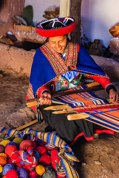 Peruvian woman weaving, The Sacred Valley, Chinchero The Sacred Valley of the Incas or Urubamba Valley is a valley in the Andes  of Peru, close to the Inca capital of Cusco and below the ancient sacred city of Machu Picchu. The valley is generally understood to include everything between Pisac  and Ollantaytambo, parallel to the Urubamba River, or Vilcanota River or Wilcamayu, as this Sacred river is called when passing through the valley. It is fed by numerous rivers which descend through adjoining valleys and gorges, and contains numerous archaeological remains and villages. The valley was appreciated by the Incas due to its special geographical and climatic qualities. It was one of the empire's main points for the extraction of natural wealth, and the best place for maize production in Peru.http://bhphoto.pl/IS/peru_380.jpg chinchero district stock pictures, royalty-free photos & images