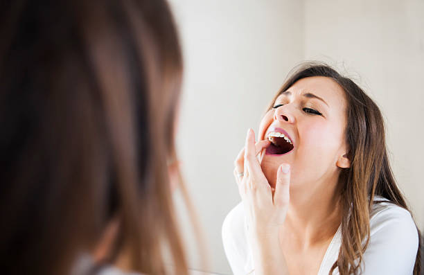 Taking care of her skin and teeth stock photo