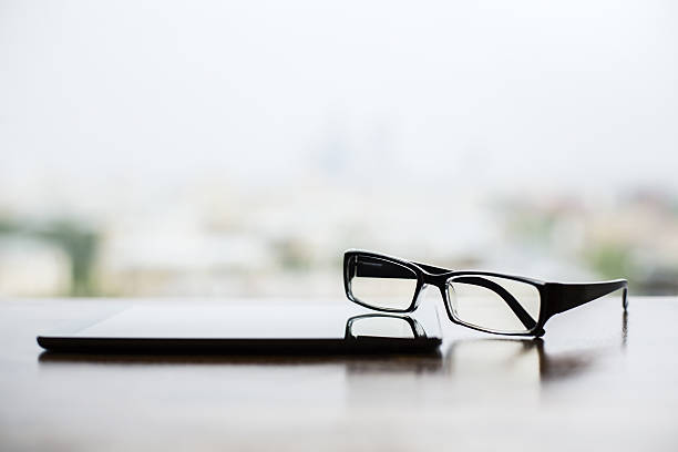 istock Smartphone and glasses closeup 629782650