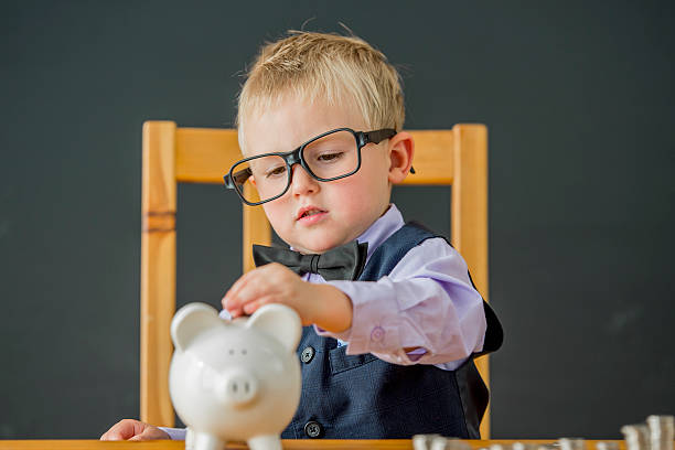 istock Putting Coins in a Piggy Bank 629783374