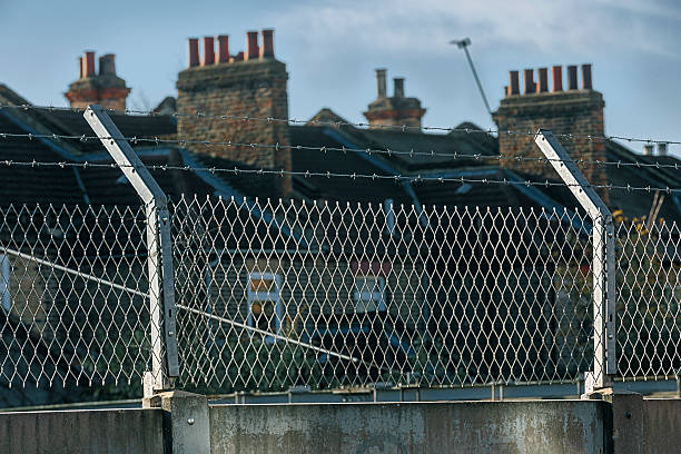 istock Building at restricted area surrounded by fence with barbed wire 629787652