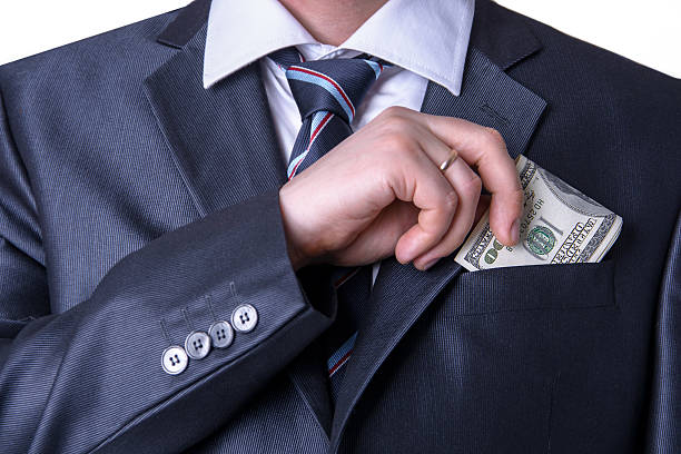 Businessman putting money in suit jacket pocket Businessman putting money in suit jacket pocketBusinessman putting money in suit jacket pocketBusinessman putting money in suit jacket pocket leather pocket clothing hide stock pictures, royalty-free photos & images