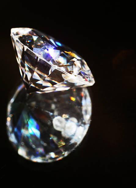 istock Transparent sparkling diamond on a dark background 629788774