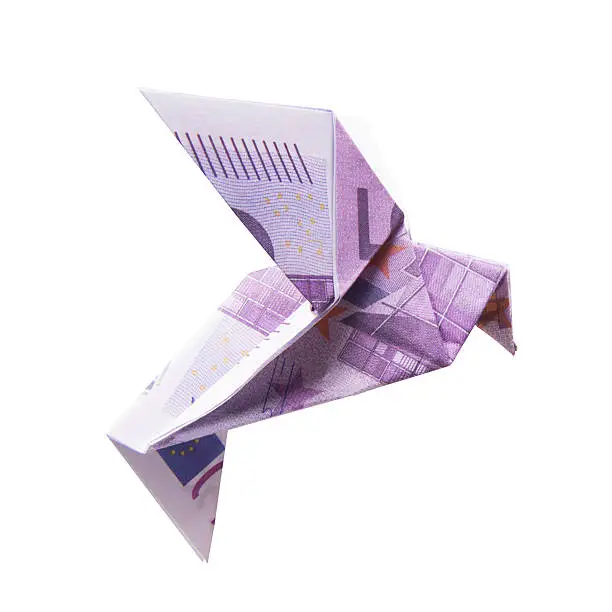 Origami Bird from banknotes on a white background