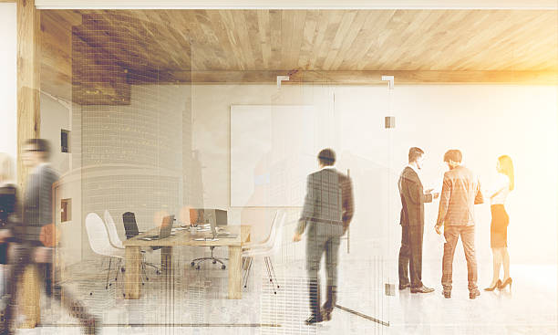 istock Man entering room with brainstorming colleagues, toned 629789988