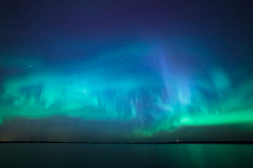 Beautiful northern lights aurora borealis over lake in finland