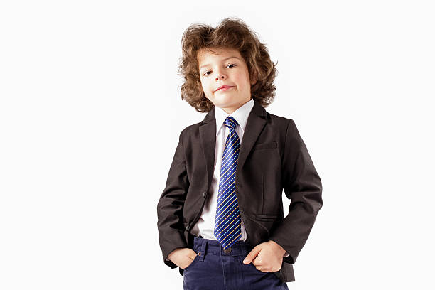 istock Curly trendy boy in a business suit standing and looking 629794366