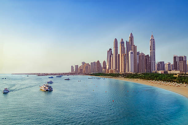 Beach and Skyline of Dubai Marina Picture of the Beach near Dubai Marina with view on the skyline. persian gulf countries stock pictures, royalty-free photos & images
