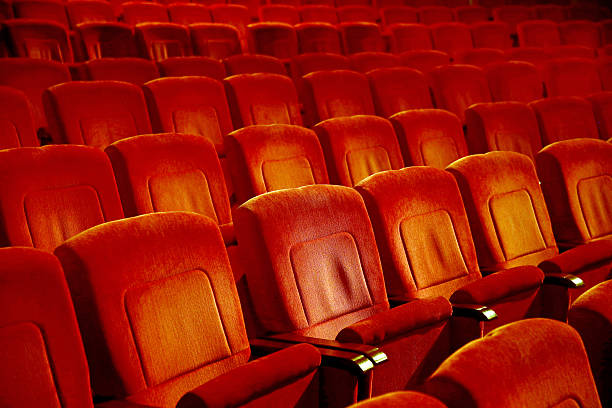 istock Interiors empty reddish cinema chairs seats in low-key indoors 629795624