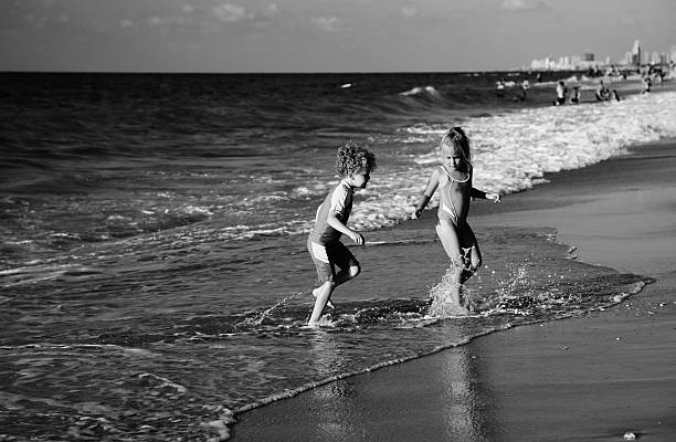 istock kids playing on the beach 629796912