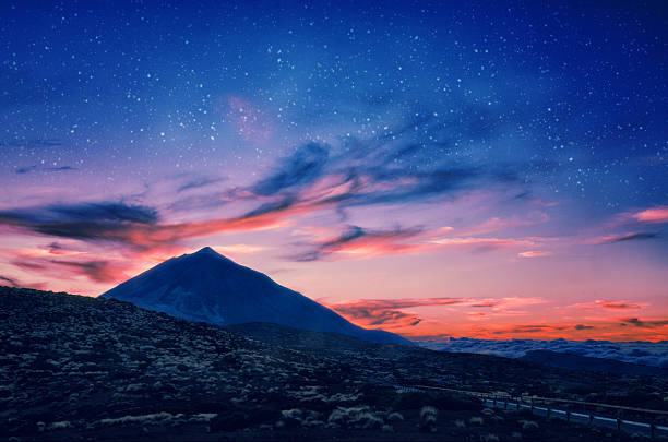 silhouette of volcano del teide against a sunset sky. - tenerife stockfoto's en -beelden