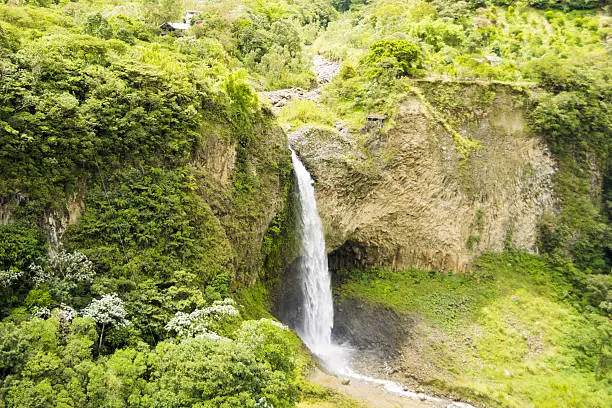A landscape view of the Manto de la Novia waterfall in the middle of the Andean region mountains near Baños, Ecuador. Sunny day.