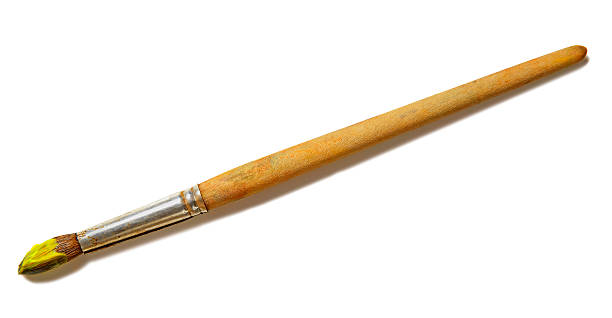 Paintbrush with yellow paint (isolated on white)