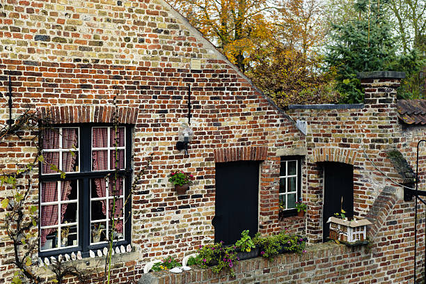 istock Brick house with windows and door in Bruges, Belgium 629801144