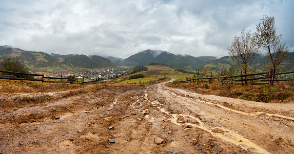 Muddy ground after rain in Carpathian mountains. Extreme path rural dirt road in the hills