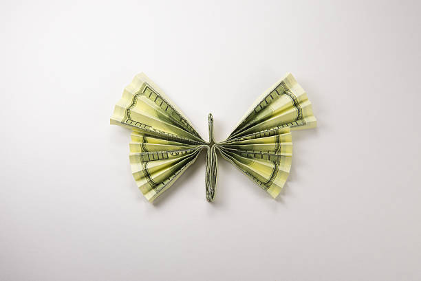 istock dollars in the form of butterflies 629803854