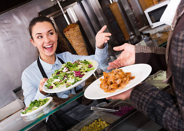 istock Girl and satisfied customer buying kebab 629804632