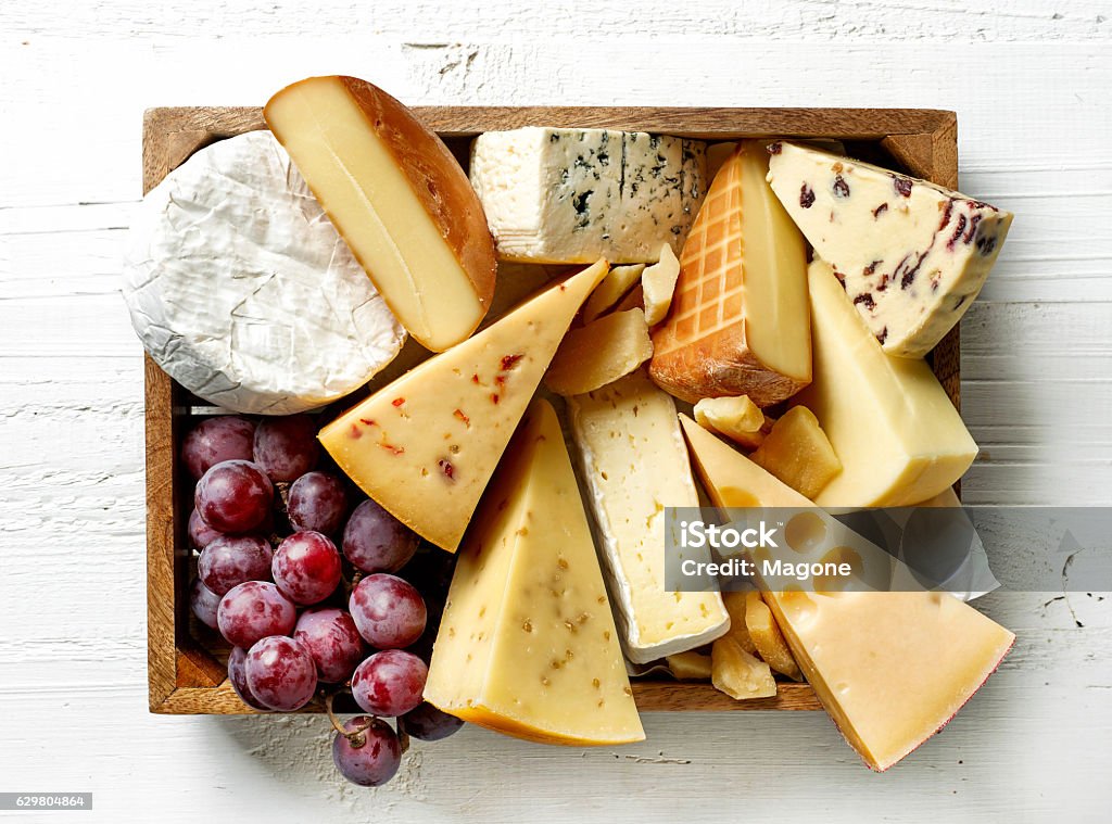 various types of cheese various types of cheese in wooden box on white wooden table, top view Cheese Stock Photo