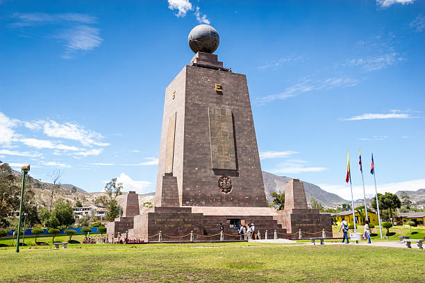 Middle of the World monument in Ecuador Quito, Ecuador - December 10, 2016: A view of th Middle of the World monument in Ecuador. It's a sunny no clouds day. Many tourist are arriving at the monument and others taking pictures from outside. equator stock pictures, royalty-free photos & images