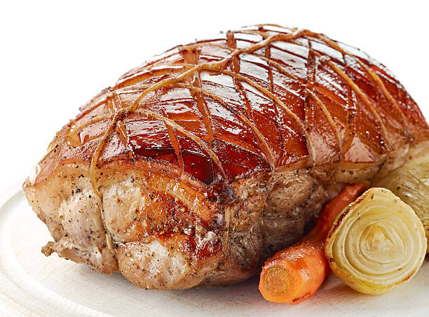 istock roasted pork on wooden cutting board 629806580