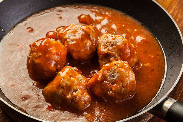 istock Meatballs with tomato sauce on black pan 629807194