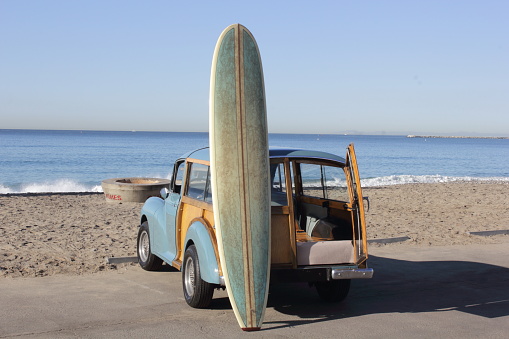 A surfboard leaning on my woody waiting for some decent waves.