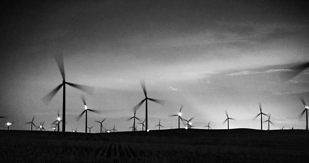 istock Wind power farm at night, illuminated by aviation safety lights 629810916