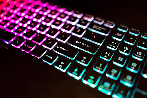 istock Closeup of colorful illuminated keyboard at night 629811194