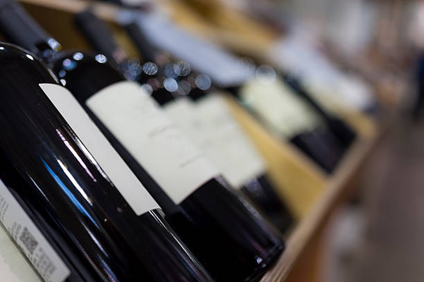 wine bottles in wooden crates on display - wine wine bottle box crate imagens e fotografias de stock