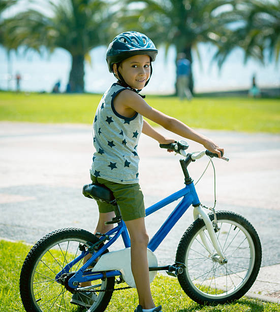 istock Little boy in helmet with rented bicycle 629811676