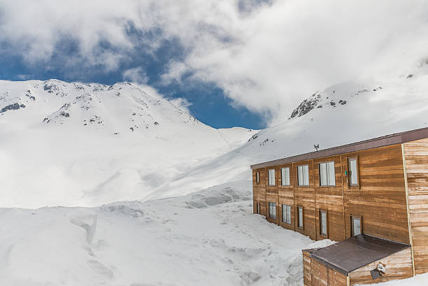 istock High mountains under snow with clear blue sky and hut. 629814718