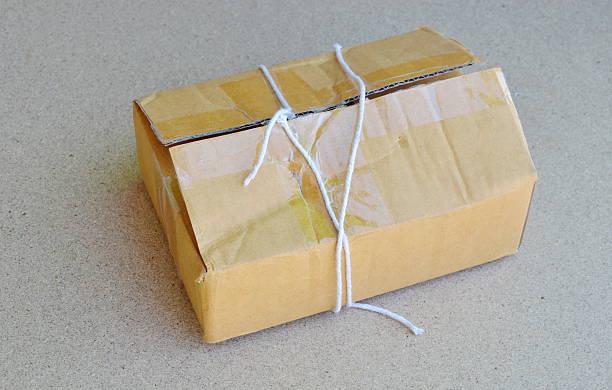istock parcel rope cut and open brown paper postbox 629820484