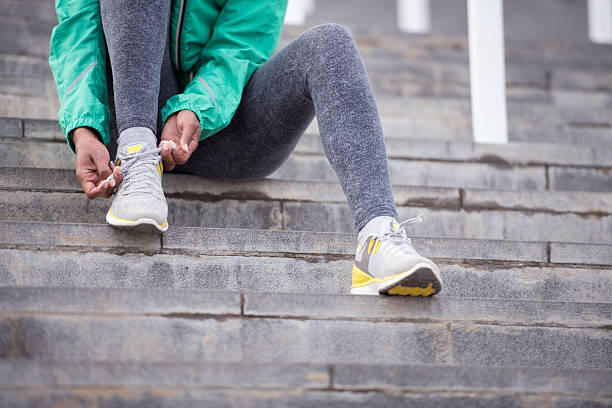 istock Woman adjusting sport shoes. 629827702