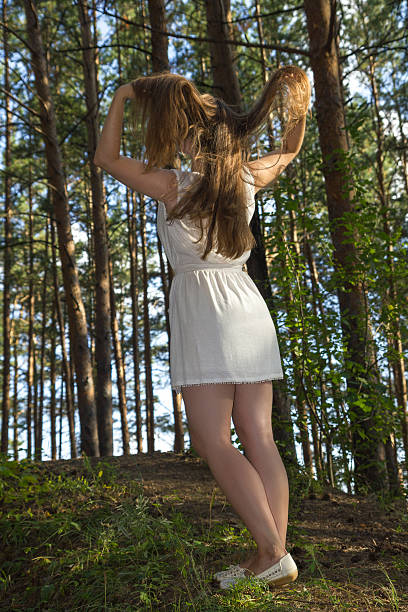 istock long hairy women posture in  coniferous  forest 629828360