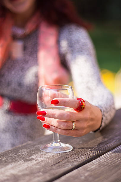 istock Female's hand holding a wine glass 629828454
