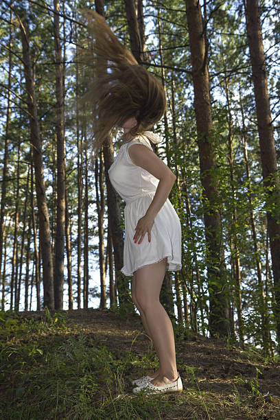 istock white women make fly hair in forest 629828550