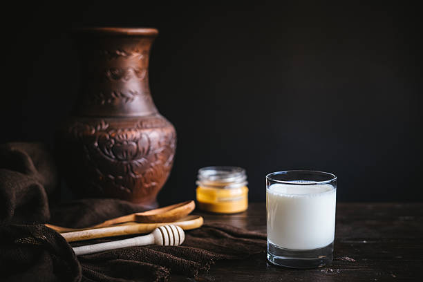 Glass jar with honey and milk stock photo
