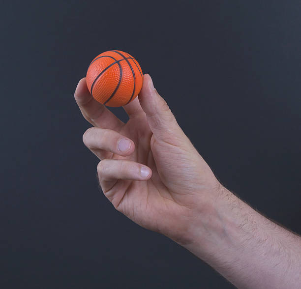 istock Isolated hand with a mini basket ball 629833518