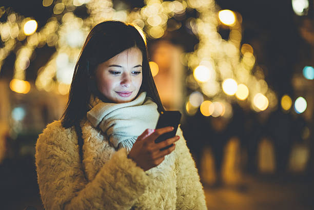 istock woman using phone in Budapest night 629836274