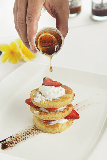 Pancakes with fresh strawberries and maple syrup