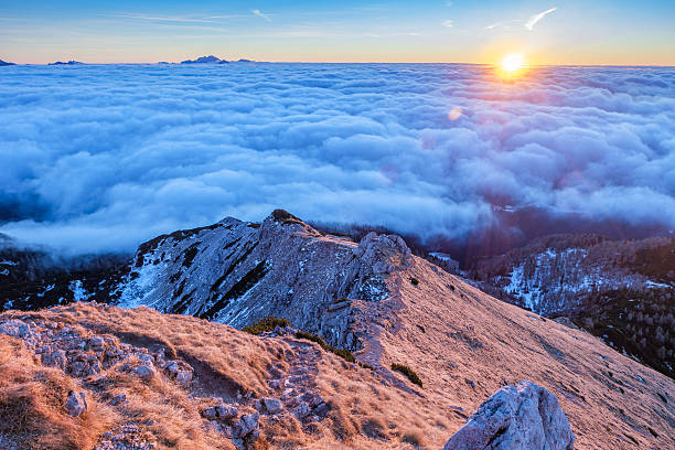 istock Mountain ridge above clouds at sunrise 629862192