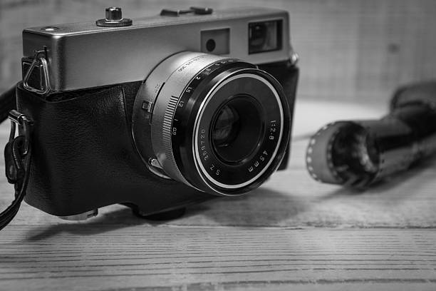 istock Retro photo camera on wooden background 629862896