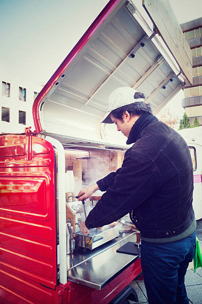 istock Man making a coffee in food truck 629863046