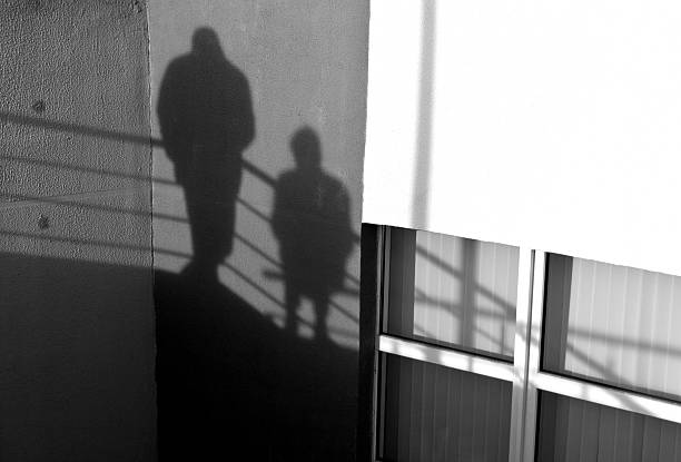 istock People silhouette on office building wall 629863112