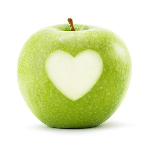 istock Green apple with heart symbol isolated on white. Clipping Path 629863526